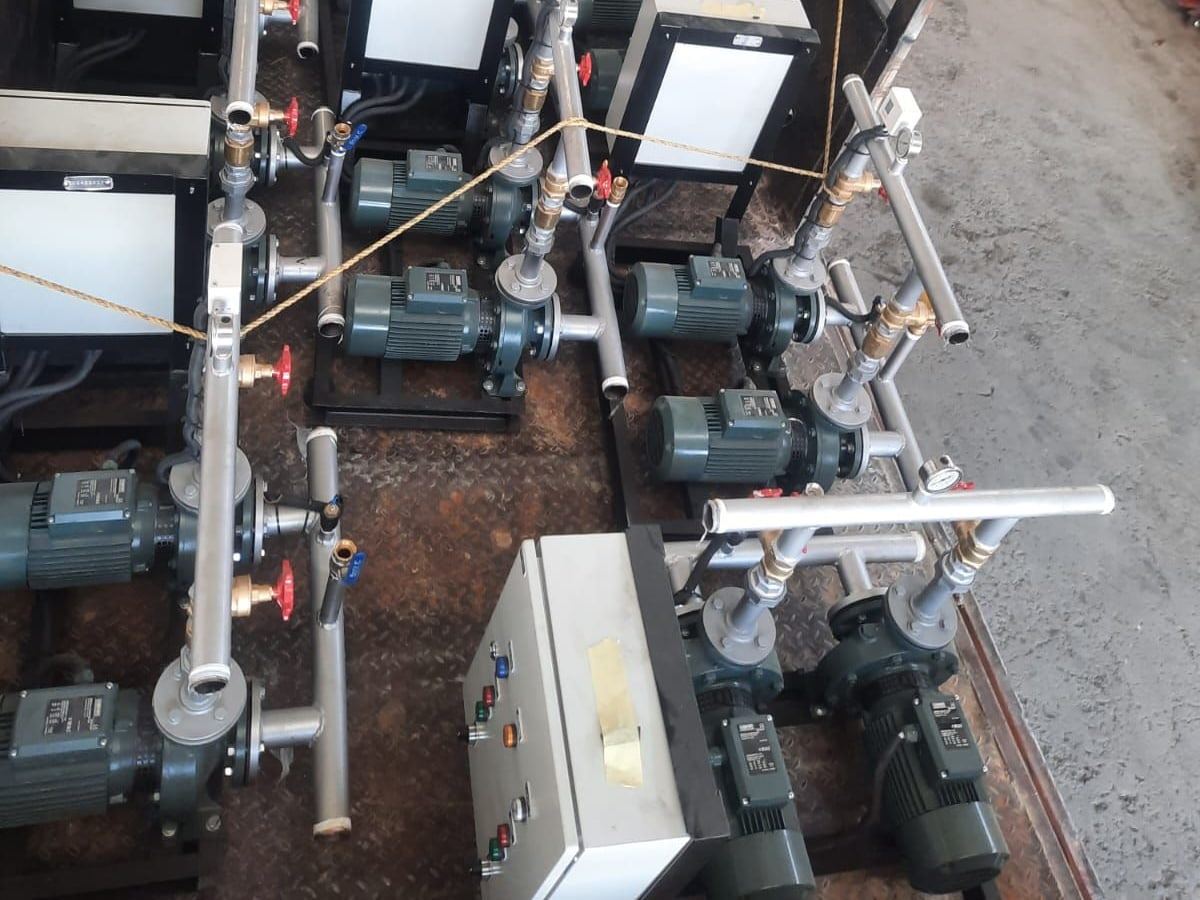 Booster sets with end-suction pumps and control boxes lashed in a truck bed for dispatch