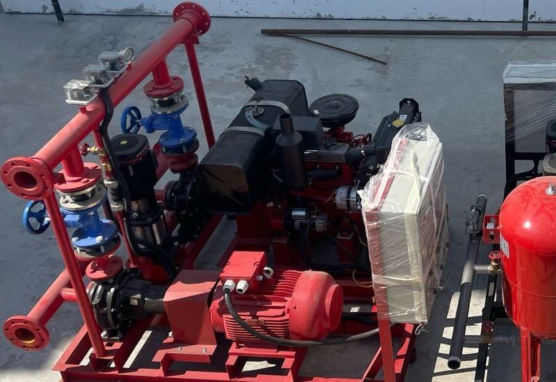 Red fire-pump set with a diesel engine, electric pump, jockey pump and controller, seen from above
