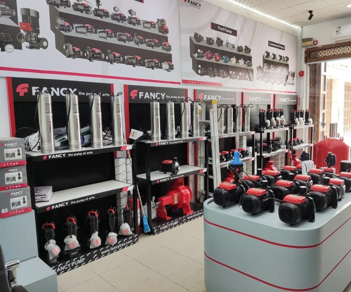 Borehole and submersible pumps on display under product posters in the Madinah showroom
